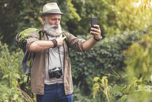 Positive Old Man Photographing Himself On Cellphone