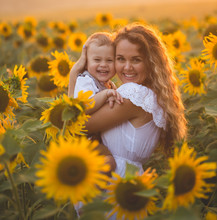 Mother With Baby Son In Sunflower Field
