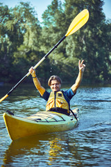 A canoe trip along the river along the forest in summer.