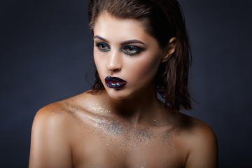 Beauty fashion model girl with bright make up. Fashion art portrait with glitters close-up