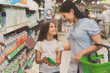 © Yakobchuk Olena - Happy girl and woman buying dairy product
