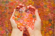 Colored balls of water beads, hydrogel in in hands. Sensory experiences