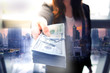© BUSARA - Business woman is offering big money (US$ Bank note) with city skyline multiple exposure graphic background.