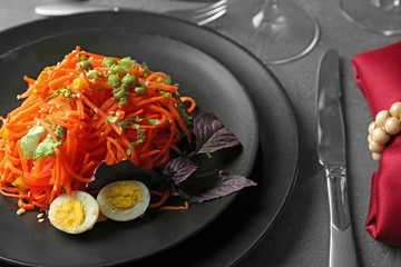 Wall Mural - Plate with delicious spicy carrot spaghetti on table