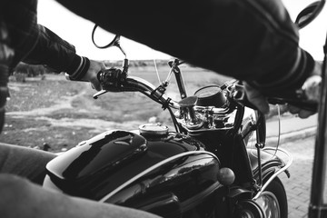 Detail of man arms on sidecar bike