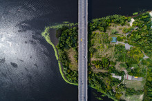 Aerial View Of The Bridge And The Road Over The Dnepr River Over A Green Island In The Middle Of The River. Kiev, Ukraine