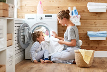 Happy Family Mother Housewife And Child   In Laundry With Washing Machine