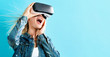 © Tierney - Happy young woman using a virtual reality headset
