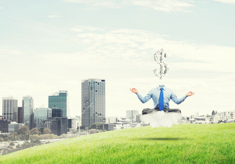 Headless meditating businessman