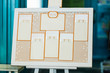 Wedding seating chart on the easel in the park.