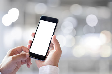 Man holding and typing text message on smart phone, Blurred background