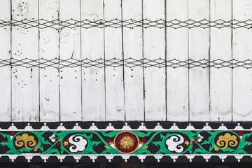 Part of traditional russian house wall with with thread patterns and ornaments. Wooden painted texture