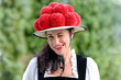 Beautiful winking german woman wearing bollenhut