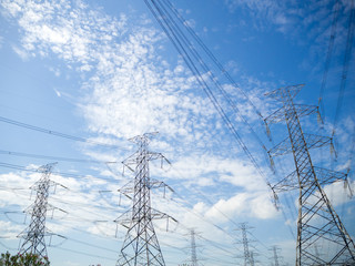 Steel electricity pylon on bright blue sky  background.