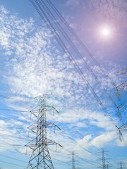 Steel electricity pylon on bright blue sky  background.