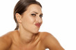 A young woman with negative expression pout her mouth