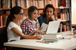 © BalanceFormCreative - Group of  female students study in the school  library.Learning and preparing for university exam.