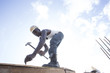 © Hugh Sitton - Man working on construction site.