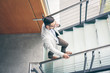 © liderina - Business man walking to work. Business man on stairs talking on smart phone.