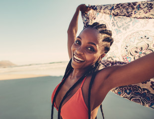 young female with scarf on beach