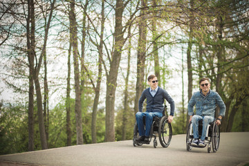 Wall Mural - Shot of a young man spending time in a park with his friend using a wheelchair