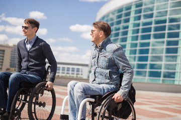 Wall Mural - Shot of a young man spending time in a park with his friend using a wheelchair