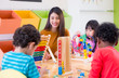 © weedezign - Asian female teacher teaching mixed race kids play toy in classroom,Kindergarten pre school concept