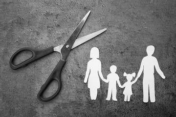 Poster - Paper silhouette of family and scissors on grey background. Life insurance concept