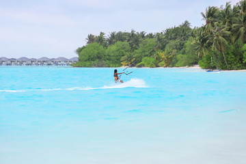 Wall Mural - Tourist kitesurfing at sea resort