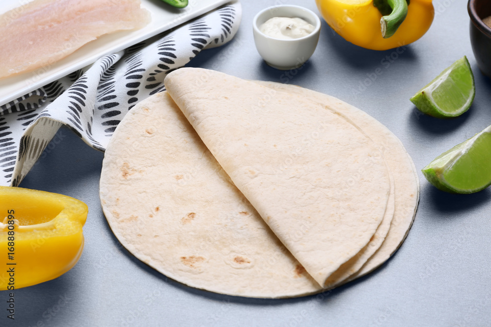 Tortillas for fish tacos on grey background