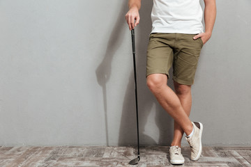 Wall Mural - Cropped image of golfer posing with club