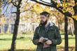 © Novoselski/Stocksy - Young man taking pictures with old camera