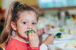 © victortorres/Stocksy - Funny kid eating healthy food at school