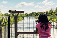 Black Girl Observing Wildlife Through Binoculars