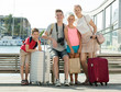 © JackF - Family of four tourists relaxing on embankment