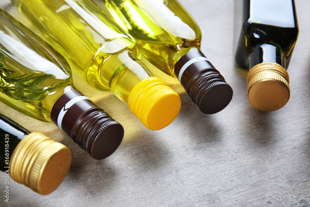 Bottles with different cooking oil on table