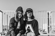 © MyMicrostock/Stocksy - Two teen-age hipster girls smiling