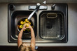 © Jessica Byrum/Stocksy - Toddler girl reaching over a sink washing yellow apples.