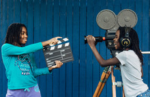 Two Black Girls Filming With A Film Camera