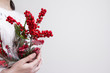 Woman hands holding ilex verticillata or winterberry for christmas decoration