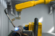 Industry 4.0 technology concept. Automate wireless welding Machine Robot arm in smart factory.