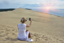 Blonde Girl Making Selfie For Instagram At Pyla Dune, The Largest Sand Dune In Europe