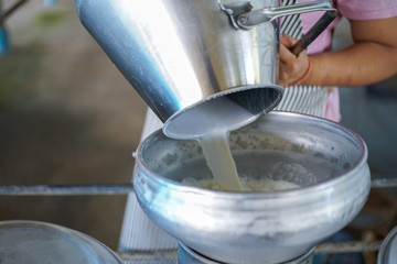 Wall Mural - Worker pouring fresh milk i