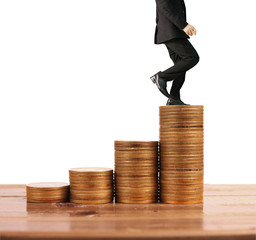 Wall Mural - Businessman walk on stack of coins which grows success