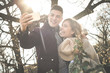 © liderina - Young couple making self-picture. Happy couple having fun in the park.