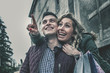 © liderina - Couple in shopping together. Happy couple shopping together and having fun. Girlfriend showing something to her boyfriend.