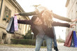 © liderina - Couple in shopping together. Happy couple shopping together and having fun. Boyfriend carrying his girlfriend on the piggyback.