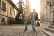© liderina - Couple in shopping together. Young couple holding hands and running trough street.