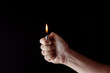 © Morocko - hand holding a lighter in a dark atmosphere