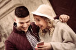 © liderina - Happy couple outdoor. Happy couple listening music on the phone.